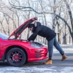 L'homme en difficulté avec sa voiture cassée. Il regarde le moteur sous Hood.